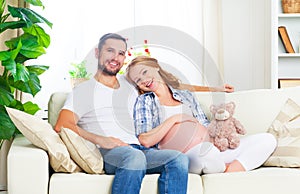 happy family in anticipation of the birth of baby. Pregnant woman and her husband at home