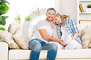 happy family in anticipation of the birth of baby. Pregnant woman and her husband at home