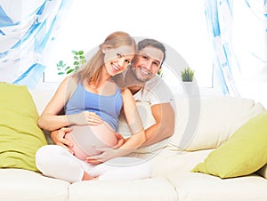 Happy family in anticipation of birth of baby. Pregnant woman an photo