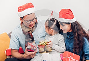 Happy family Asia family wear santa claus hat exchange Christmas