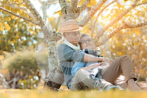 Happy family asian senior couple retirement sitting and hugging smile in nature