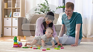 Happy family with baby boy playing at home