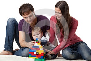 Happy family with baby build house.