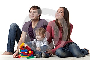 Happy family with baby build house.