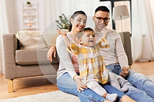 Happy family and baby daughter playing at home