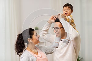 Happy family and baby daughter playing at home