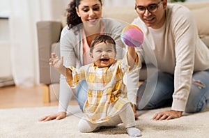 Happy family and baby daugter playing at home