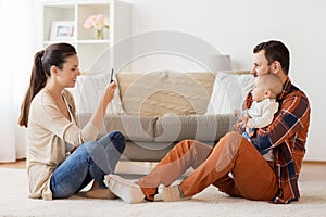 Happy family with baby photographing at home