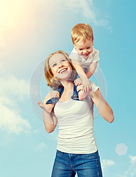 Happy family. baby sits astride the shoulders of the mother and