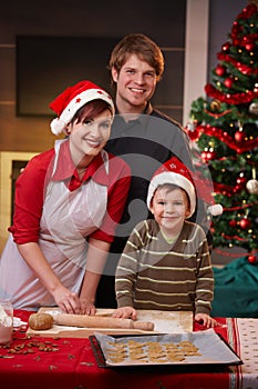 Happy family baking christmas cake together