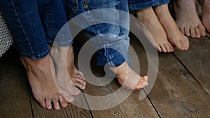 Happy family. Barefoot at wooden floor