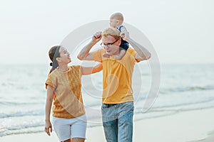 Happy family on the beach.  Father, mother and baby having fun on summer vacation. Holiday travel concept