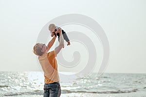 Happy family on the beach.  Father, mother and baby having fun on summer vacation. Holiday travel concept