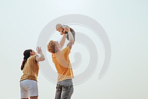 Happy family on the beach.  Father, mother and baby having fun on summer vacation. Holiday travel concept