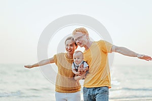 Happy family on the beach.  Father, mother and baby having fun on summer vacation. Holiday travel concept