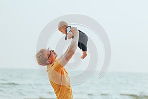 Happy family on the beach.  Father, mother and baby having fun on summer vacation. Holiday travel concept