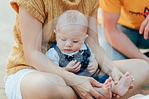 Happy family on the beach.  Father, mother and baby having fun on summer vacation. Holiday travel concept