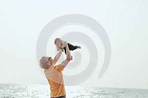 Happy family on the beach.  Father, mother and baby having fun on summer vacation. Holiday travel concept