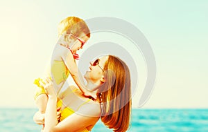 Happy family on the beach. mother and child daughter