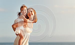 Happy family at beach. mother hugging child daughter