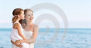Happy family at beach. mother hugging child daughter
