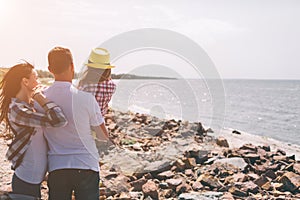 Happy family on the beach. People having fun on summer vacation. Father, mother and child against blue sea and sky