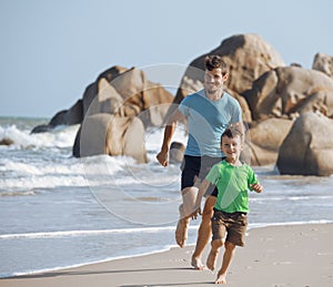 Happy family on beach playing, father with son