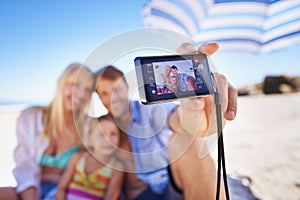 Happy family, beach and selfie with camera for photography, picture or moment in outdoor nature. Mother, father and