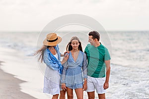 Happy family on the beach during summer vacation