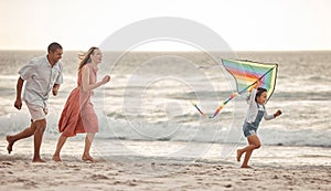 Happy family, beach vacation and child flying kite while running by the sea with her mother and father. Energy, fun and