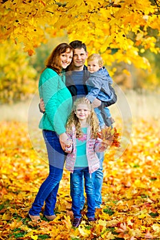 Happy family in a beautiful autumn park