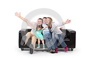Happy family on black leather sofa