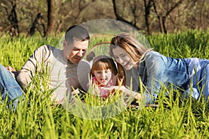 Happy family blowing soap bubbles in park