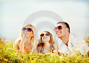 Happy family with blue sky and green grass