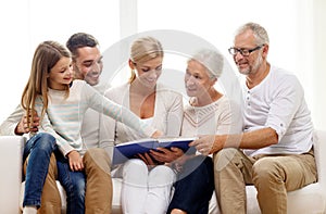 Happy family with book or photo album at home