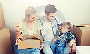 Happy family with boxes moving to new home