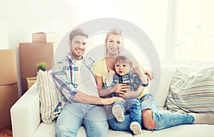 Happy family with boxes moving to new home