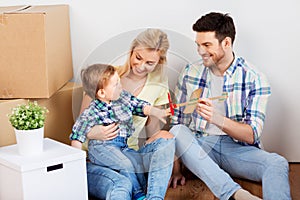 Happy family with boxes moving to new home