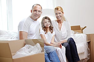 Happy family with boxes moving to new home