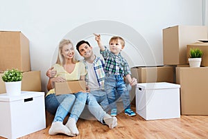 Happy family with boxes moving to new home