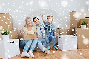 Happy family with boxes moving to new home