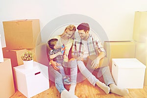 Happy family with boxes moving to new home