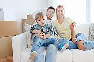 Happy family with boxes moving to new home