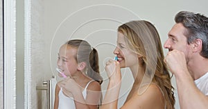 Happy family brushing teeth