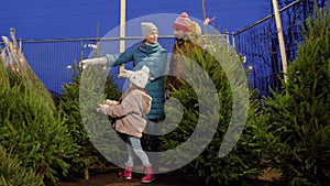 Happy family buying christmas tree at market