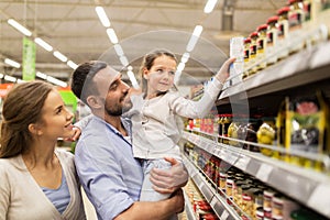 Happy family buying food at grocery store