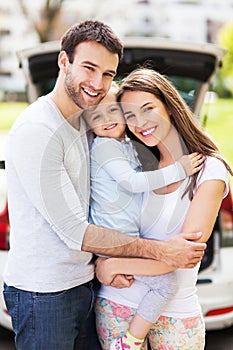 Happy family with car on background