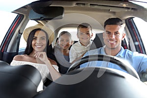 Happy family in car on road trip