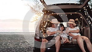 Happy Family with car travel and camping road trip. summer vacation in car in the sunset, Dad, mom and daughter happy traveling