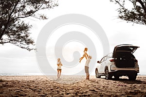 Happy Family with car travel road trip. summer vacation in car in the sunset, Dad, mom and daughter happy traveling enjoy together